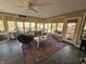 Bright sunroom with large windows, seating area, and deck access at 620 Valley Dr, Martinsville, IN 46151