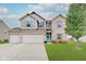 Two-story brick home with a 3-car garage and landscaped lawn at 7102 Beal Ln, Indianapolis, IN 46217