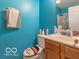 Small bathroom with teal walls and wood vanity at 304 Chestnut St, Danville, IN 46122