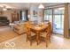 Bright dining area with wood table and chairs, open to living room at 304 Chestnut St, Danville, IN 46122
