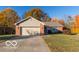 Brick ranch home with attached garage and autumn trees at 304 Chestnut St, Danville, IN 46122