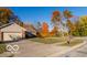 Ranch home with driveway and mature trees in the fall at 304 Chestnut St, Danville, IN 46122