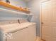 Convenient laundry room with washer, dryer, and overhead shelving at 304 Chestnut St, Danville, IN 46122