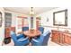 Round wooden dining table with blue chairs and patio access at 8191 Frisco Way, Indianapolis, IN 46240