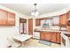 View of kitchen with wood cabinets, sink, and access to a deck at 8191 Frisco Way, Indianapolis, IN 46240