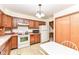 Bright kitchen with wood cabinets, white appliances, and a breakfast nook at 8191 Frisco Way, Indianapolis, IN 46240