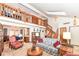 High-ceilinged living room with a stone fireplace, loft, and stairs at 8191 Frisco Way, Indianapolis, IN 46240