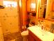 Bathroom with toilet, sink, shower and wood cabinets at 821 N Tuxedo St, Indianapolis, IN 46201