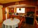 Small kitchen with wood cabinets and appliances at 821 N Tuxedo St, Indianapolis, IN 46201