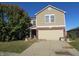 Two-story house with a beige exterior, brick accents, and a two-car garage at , Greenwood, IN 46143