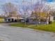 Gray house with carport and mature trees in the front yard at 943 N 12Th St, Elwood, IN 46036