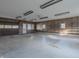 Ample garage space with shelving and a large door at 943 N 12Th St, Elwood, IN 46036