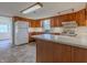 Kitchen with wood cabinets, white appliances, and tile floor at 943 N 12Th St, Elwood, IN 46036