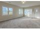 Bright living room with neutral carpeting and large windows at 943 N 12Th St, Elwood, IN 46036