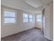 Sunroom features gray flooring and multiple windows at 943 N 12Th St, Elwood, IN 46036