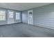 Sunroom addition with gray carpeting and exterior access at 943 N 12Th St, Elwood, IN 46036