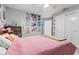 Bedroom with pink bedding and gallery wall at 1285 Greenwood Station Blvd, Greenwood, IN 46143
