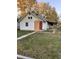 White house with a red door and yard needs some repairs at 1656 Nelson Ave, Indianapolis, IN 46203