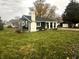 Charming ranch home with dark exterior, white trim, and a well-manicured lawn at 1902 Silver St, Anderson, IN 46012