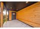 Covered back patio with wood siding and concrete flooring at 425 Sanders St, Indianapolis, IN 46225