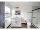 Modern bathroom with white vanity, walk-in shower, and dark wood floors at 425 Sanders St, Indianapolis, IN 46225
