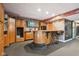 Basement wet bar with wood cabinetry, granite countertop, and bar stools at 5784 N 600 E, Greenfield, IN 46140