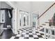 Two-story foyer with checkerboard floor and elegant staircase at 5784 N 600 E, Greenfield, IN 46140