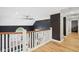 Upper level hallway featuring hardwood floors and a modern railing at 5784 N 600 E, Greenfield, IN 46140