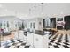 Spacious kitchen with white cabinets, black countertops, and a checkerboard floor at 5784 N 600 E, Greenfield, IN 46140