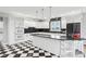 Bright kitchen boasts white cabinets, dark tile backsplash, and a sizable island at 5784 N 600 E, Greenfield, IN 46140