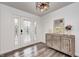 Bright entryway with a rustic console table, wood-look floors, and a glass door at 5909 Buttonwood Dr, Noblesville, IN 46062