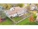 Aerial view showcasing home's backyard, fence, and fall foliage at 5909 Buttonwood Dr, Noblesville, IN 46062