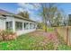 Spacious backyard with a patio, surrounded by a wooden fence and autumn leaves at 5909 Buttonwood Dr, Noblesville, IN 46062