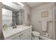 Clean bathroom with a white vanity, grey tile shower, and toilet at 5909 Buttonwood Dr, Noblesville, IN 46062