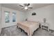 Bright bedroom with a queen bed, two windows, and ceiling fan at 5909 Buttonwood Dr, Noblesville, IN 46062