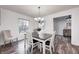 Bright dining room with a farmhouse table and chandelier, view of kitchen at 5909 Buttonwood Dr, Noblesville, IN 46062