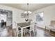 Spacious dining area with wood table, chandelier, and access to kitchen at 5909 Buttonwood Dr, Noblesville, IN 46062