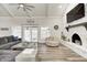 Spacious living room featuring a stone fireplace, vaulted ceiling and hardwood floors at 5909 Buttonwood Dr, Noblesville, IN 46062