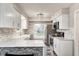 Modern kitchen with white cabinets, marble countertops, and stainless steel appliances at 5909 Buttonwood Dr, Noblesville, IN 46062