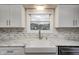 Modern farmhouse kitchen sink with marble countertops and white shaker cabinets at 5909 Buttonwood Dr, Noblesville, IN 46062