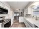 Updated kitchen featuring white cabinets, marble countertops, and stainless steel appliances at 5909 Buttonwood Dr, Noblesville, IN 46062