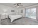 Bright main bedroom with a king bed and sliding glass doors at 5909 Buttonwood Dr, Noblesville, IN 46062