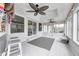 Enjoy this screened porch with a tiki bar and ceiling fans at 5909 Buttonwood Dr, Noblesville, IN 46062
