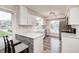 Modern kitchen with white cabinets, granite countertops and stylish backsplash at 5909 Buttonwood Dr, Noblesville, IN 46062