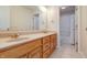 Bathroom boasts double sinks, wood cabinets, and a tub at 7290 Lockford Walk N, Avon, IN 46123