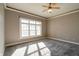 Bright bedroom with large window, ceiling fan, and neutral carpeting at 7290 Lockford Walk N, Avon, IN 46123
