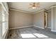 Spacious bedroom with large window, ceiling fan, and neutral carpeting at 7290 Lockford Walk N, Avon, IN 46123