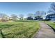 Lovely community green space with walking path and homes in the background at 7290 Lockford Walk N, Avon, IN 46123