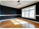 Sunlit dining room features hardwood floors, large windows, and elegant chandelier at 7290 Lockford Walk N, Avon, IN 46123