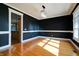 Elegant dining room with hardwood floors, dark walls, and a chandelier at 7290 Lockford Walk N, Avon, IN 46123